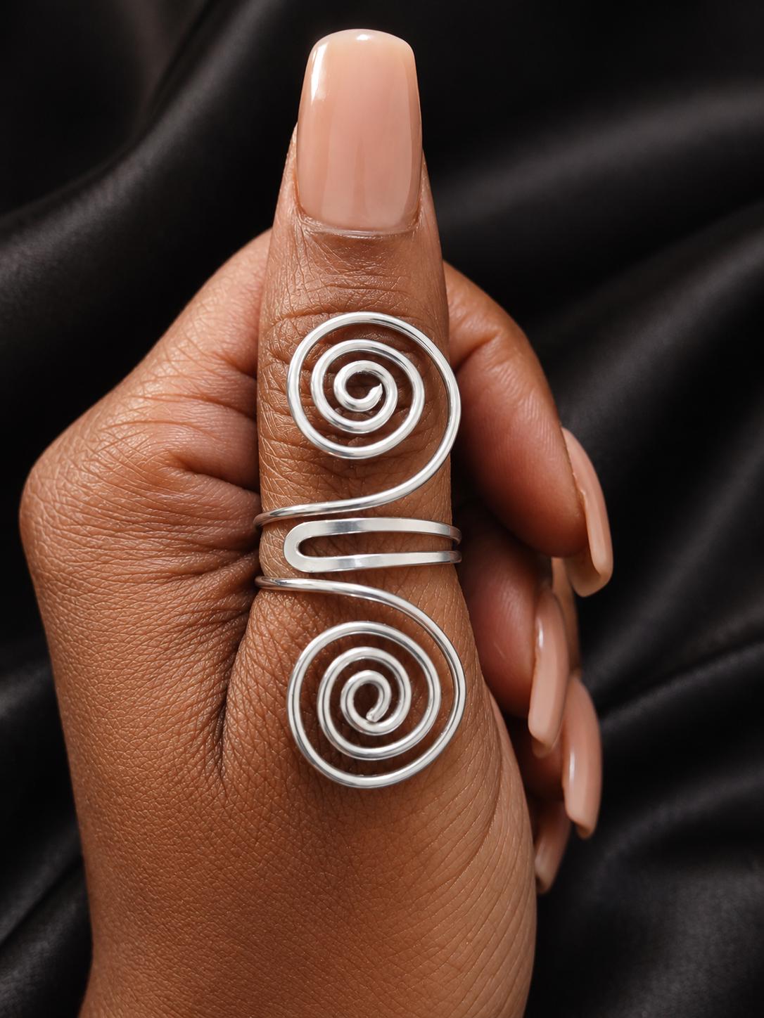 The Genesis Spiral Ring, two prominent silver spirals joined by a curved bridge.