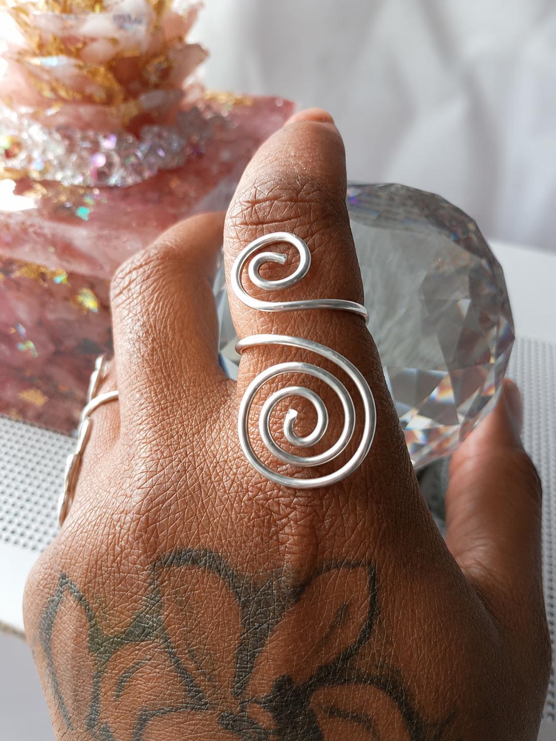 The House Spiral ring in sterling silver, worn on the hand.